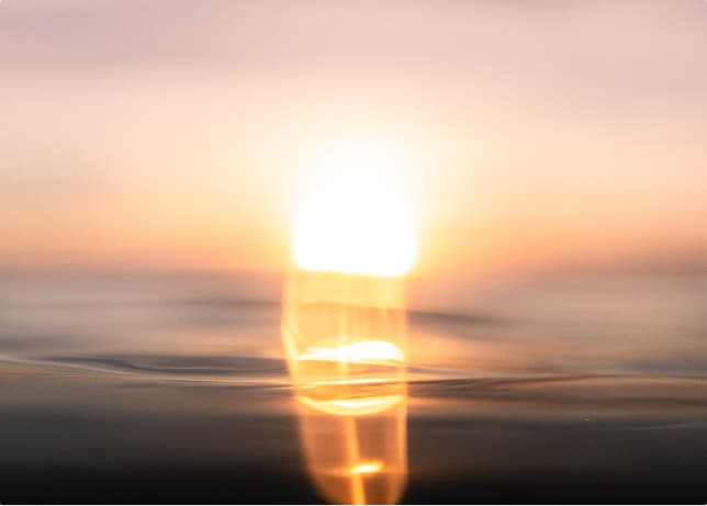 Soft sunrise over calm water.
